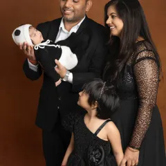 A candid moment of love as the parents and big sister admire the sleeping newborn. These are the unscripted interactions that tell the true story of a family.