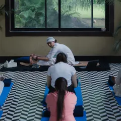 A view from the back of our class, showing the shared focus and dedication of the Sangat. I often provide gentle adjustments to help students deepen their practice safely.
