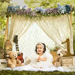 A sweet smile from our little rockstar. The combination of a guitar, teddy bears, and a beautiful floral and macrame backdrop creates a unique and charming boho-chic vibe.