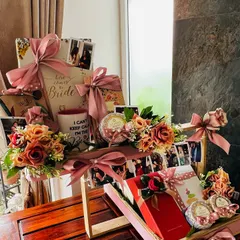 This shot captures the full scale of the bespoke bridal hamper. It shows how multiple elements, from photo displays and floral arrangements to individually wrapped gifts, come together to create a grand and impressive statement piece.