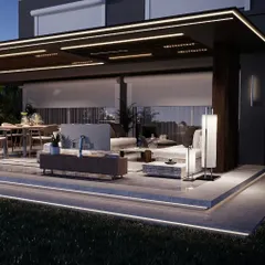 This view highlights the layered lighting design of the backyard project, with LED strips along the platform edge, recessed ceiling lights, and accent sconces. This creates a warm, inviting glow throughout the entire outdoor living space.