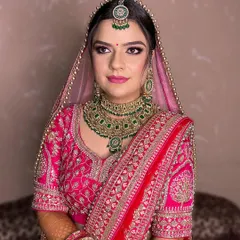 A closer look at this bride's soft and pretty-in-pink makeup. The focus is on a flawless base, gentle color on the eyes and cheeks, and a lip color that complements her outfit perfectly.