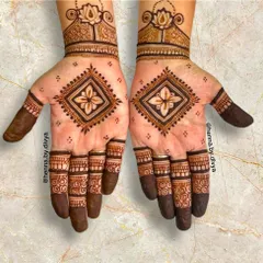 This design features a bold, diamond-shaped geometric motif on the palm. Paired with a lotus cuff, it's a powerful and modern design that makes a statement.