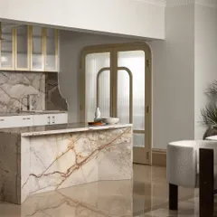 This breakfast island and kitchen is a study in quiet luxury, where a sculptural marble island takes center stage. We balanced the strength of the stone with golden-framed glass cabinets and curved door frames, creating a space that feels as effortless as it is elegant.