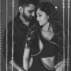 An intimate black and white portrait of an expecting couple. The focus is entirely on their connection and the anticipation of their new arrival, creating a powerful and timeless image.