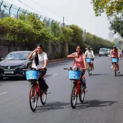 Smiles for miles. Two riders share a happy moment while cycling through the city. The simple joy of riding with a friend is what our tours are all about.