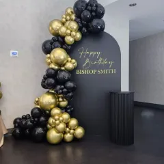 An elegant and minimalist birthday backdrop perfect for adult celebrations. This design uses a sophisticated black and gold color scheme, with a custom "Happy Birthday" message on a clean, arched backdrop, accented by a chic balloon garland.