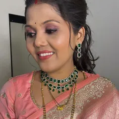 A close-up of the reception makeup, featuring shimmery pink eyeshadow and a matching lip color for a cohesive, elegant look.