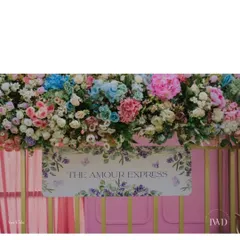 A close-up of the signage on 'The Amour Express'. Every detail, from the name to the floral decor, was designed to celebrate the couple's unique love story.