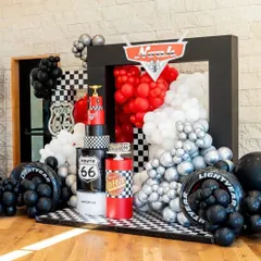 I bring high-octane fun with themes like Disney's Cars. This setup features a bold color scheme, a checkered floor, and iconic elements like the Route 66 sign and Rust-eze branding, creating a perfect racetrack atmosphere for any car enthusiast's birthday party.