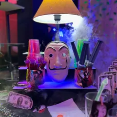 Your bar should match your vibe, no matter how unique. For this event, I designed a complete Money Heist themed bar, complete with Dali masks, custom cocktail names, and even drink "syringes" to fit the theme.