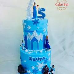 This two-tier Frozen cake brings the entire kingdom of Arendelle to the party. It features Elsa on top, with Anna, Kristoff, Sven, and Olaf around the base, all set against an icy blue castle design.