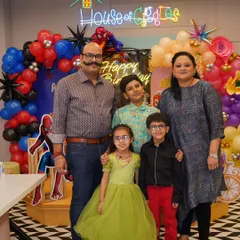 A perfect family portrait against a vibrant, superhero-themed backdrop. My goal is to create beautiful settings that result in cherished family photos and memories of your child's special day.