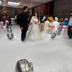 A wide shot of the couple's grand entrance, walking on a cloud of dry ice. This special effect adds a touch of fairytale magic to any engagement or reception.