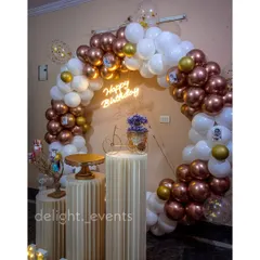 This elegant birthday decoration features a full ring balloon arch with on-trend chrome and white balloons. We added a custom neon sign and classic fluted pedestals to create a sophisticated and picture-perfect spot for celebrating.