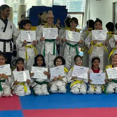 A proud moment for our SKYe kids. Posing with their new belts and certificates, these students show the joy and confidence that comes from achieving a new rank in their Taekwondo training.