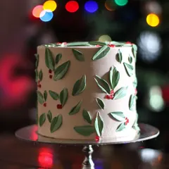 This holiday cake design came to me on a whim, and I absolutely love its simple elegance. It’s flying out of my kitchen this season! The bokeh from the Christmas tree lights in the background adds a little extra magic.