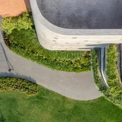 This aerial view shows how I use soft, flowing lines in my planting design to wrap around the hard edges of architecture. The green borders and pathways guide movement and create a sense of harmony.