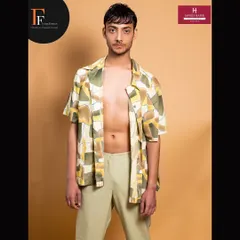 A full-length shot of the male model, showing how subtle makeup and grooming contribute to a professional, high-fashion look.
