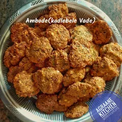 A fresh batch of Ambode, or Kadlebele Vade, ready for a function. These crispy, savory fritters are made from chana dal and spices, perfect for any gathering.