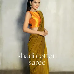 Breezy, breathable, beautiful. This Khadi cotton saree, paired with a vibrant sleeveless orange blouse, is your best pick for sunny days and summer soirées. Stay cool, stay classic.