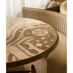 We see dining tables as centerpieces for stories and meals. This piece features a custom marble inlay top with sinuous patterns inspired by illustrator Jane Foster, crafted from Crema Marfil and Federal Beige marble. It’s paired with a fluted banquette, creating an intimate and artistic dining nook.
