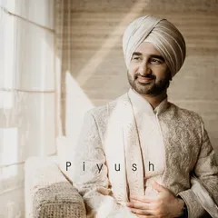 A groom enjoying a moment of calm before the wedding. The warm sunlight streaming through the window highlights his thoughtful expression and elegant attire.