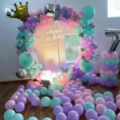 This butterfly and princess theme decoration uses a pastel balloon ring arch. I added butterfly cutouts, a crown foil balloon, and a large number '7' pillar for the birthday girl.