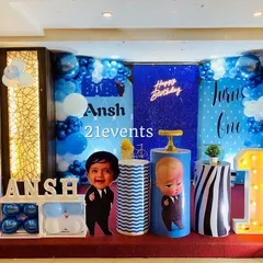 The Boss Baby theme is perfect for a little one's big day. This decoration package includes character cutouts, a blue and white balloon arrangement, a personalized backdrop with a neon sign, and themed dessert stands.