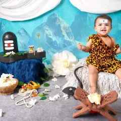 Our little Shivji, full of smiles. This sitter session captures the joyful side of a baby dressed as Lord Shiva, set against a backdrop of Mount Kailash.