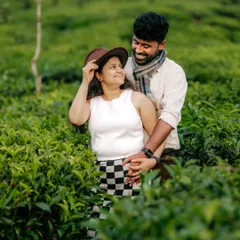 A playful and romantic moment captured in a tea garden, this photo showcases how natural surroundings can enhance the story of a couple's love.