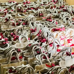 Scale and consistency are key for corporate orders. Here are hundreds of eco-friendly jute bags, each filled and ready for a large corporate event, showing my capability to handle bulk gifting requirements.