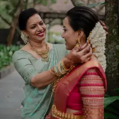 A mother's loving touch as she helps her daughter with her hair. These tender, behind-the-scenes moments are a beautiful part of the wedding story.