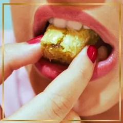 That first bite feeling. A close-up capturing the indulgent and satisfying experience of eating a piece of our authentic, crispy baklava.