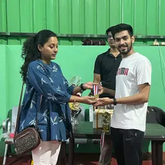 Presenting a medal during the awards ceremony for our internal singles league. I believe every participant's effort deserves to be celebrated at the end of a hard-fought tournament.