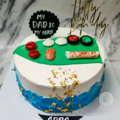 A special cake for a foodie dad! This one features his favorite sushi rolls made from fondant, on a delicious Rasmalai cake.