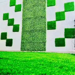 We love getting creative with our installations. Here, we used squares of artificial grass to create a modern, geometric pattern on an exterior wall, complementing a central vertical garden panel.