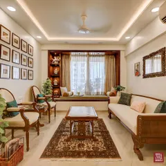 This living room is a celebration of classic Indian comfort and timeless design. Every element, from the custom-carved wooden furniture and handwoven rug to the curated gallery wall, was thoughtfully designed by me to create a warm, inviting, and personal family space.