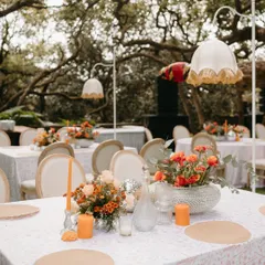 From the meticulously set tables to the elegant decor, every detail came together to create a breathtaking experience. The custom lamps, orange candles, and floral centerpieces added a warm and intimate glow to the guest tables.