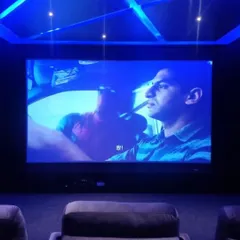 This is the view from your seat. We meticulously plan screen size and seating distance to create an engaging cinematic experience, complemented by ambient ceiling lights that don't distract from the picture.