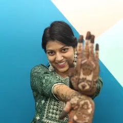 A playful pose by the bride, showing off her henna-adorned hands. We work with you to get a variety of shots for your mehandi photography, from candid to posed.