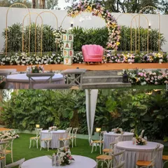 A beautiful baby shower setup at The Backyard. The stage is decorated with a floral arch and "BABY" blocks, while the lawn provides ample seating for guests.
