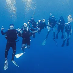 This is what it's all about. A group of divers, our new friends, exploring the incredible blue of Lakshadweep together. The camaraderie we build underwater is just as important as the marine life we see. This is our dive tribe.
