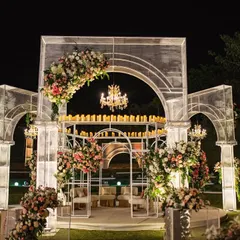 The mandap, lit for a magical night. The clean lines of the wire mesh structure, adorned with floral arrangements and crowned with candles, created a breathtaking focal point against the starry sky.