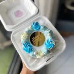 A beautiful blue and white bento cake with a gold "Happy Birthday" charm. The delicate piping and pearl details make this mini cake extra special.