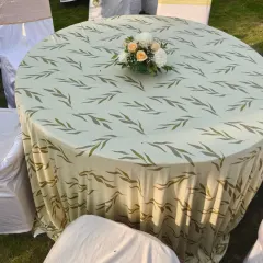 Even the table linens are part of the overall design. This table is covered with a beautiful leaf-patterned cloth, topped with a simple but elegant floral centerpiece for a Haldi lunch.