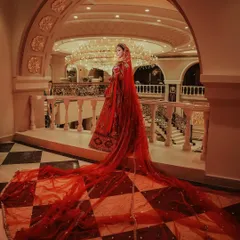 We believe a bride's entrance is a moment of pure magic. This shot captures the grandeur of a bridal lehenga with a dramatic, flowing veil, creating an iconic image that feels like a scene from a fairytale. It showcases our ability to frame monumental moments with an artistic eye.
