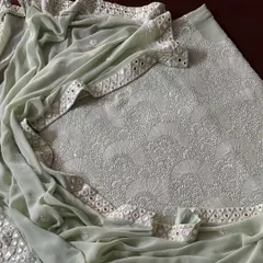 Experience modern elegance with our Mint Green suit in pure georgette. The fabric is adorned with a heavy 'Teen Taar' Chikankari jaal, which is further illuminated by Poth, Kutdana, and a handcrafted Kutchi mirrorwork border for a touch of refined glamour.