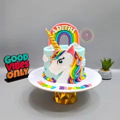 A magical unicorn cake with a rainbow mane and a golden horn. This is one of my most requested designs for little girls.