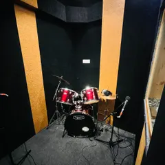 Our dedicated, acoustically treated drum room, equipped with a full drum kit and microphones, ready for a lesson or practice session.